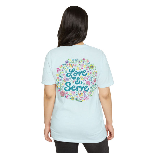 Light blue t-shirt with 'Love & Serve' design on the back, worn by a person.